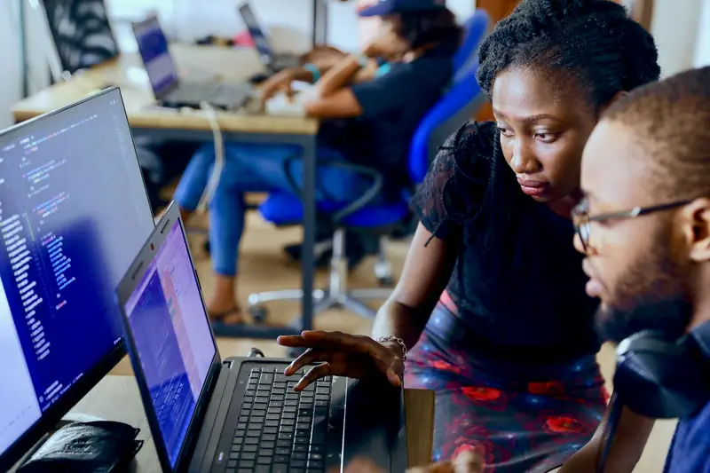 Une développeuse écrit du code sur son ordinateur